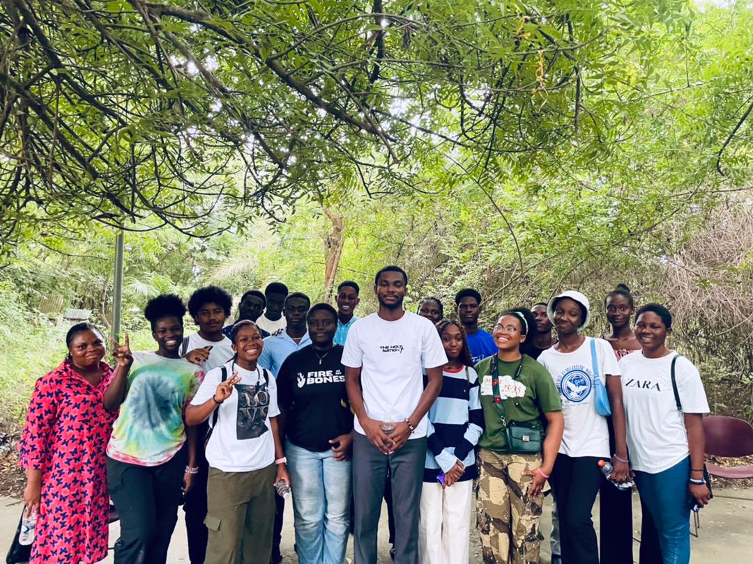 A Kings & Priests member lifts a black shirt overhead, revealing tattoos while shaking off shame.