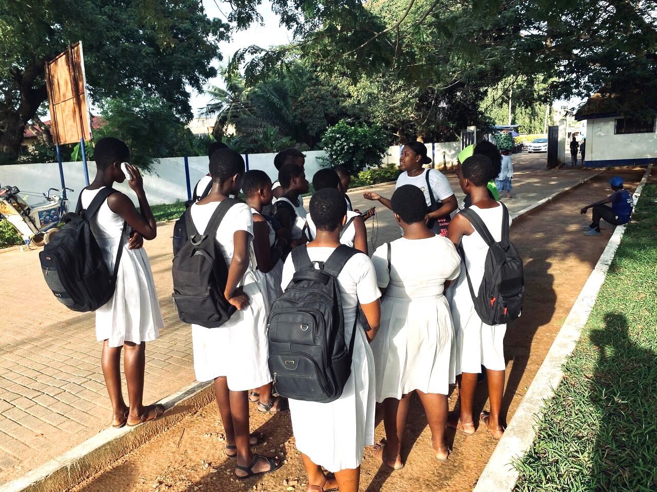 Kings & Priests yearbook group gathered in bright white light, surrounding each other in celebration.