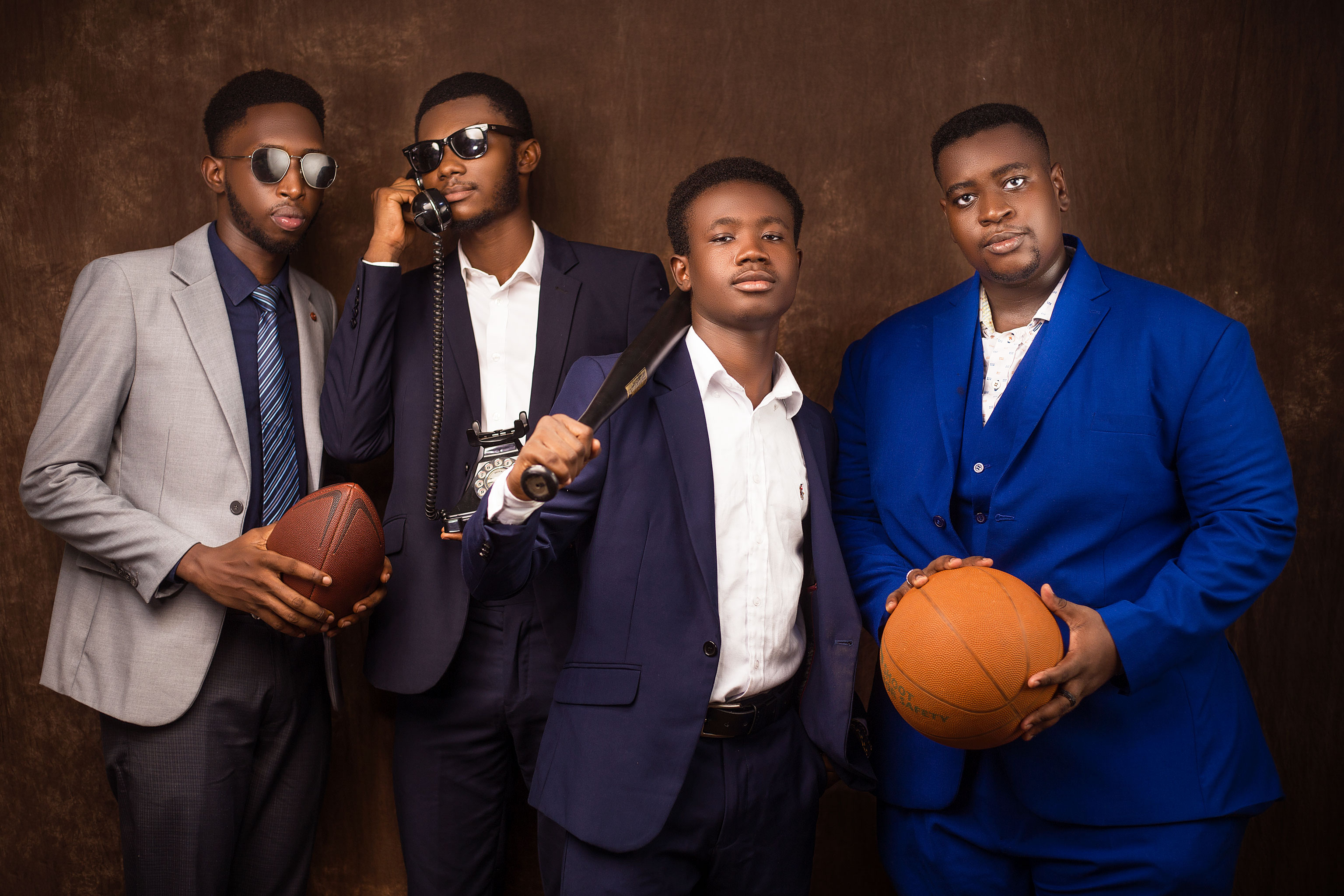 Five Kings & Priests organizers stand on a graffiti-covered staircase holding handmade protest signs that call for queer joy.